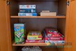Games, cards, and puzzles for fun are located in the hall closet between the TV room and third bedroom.